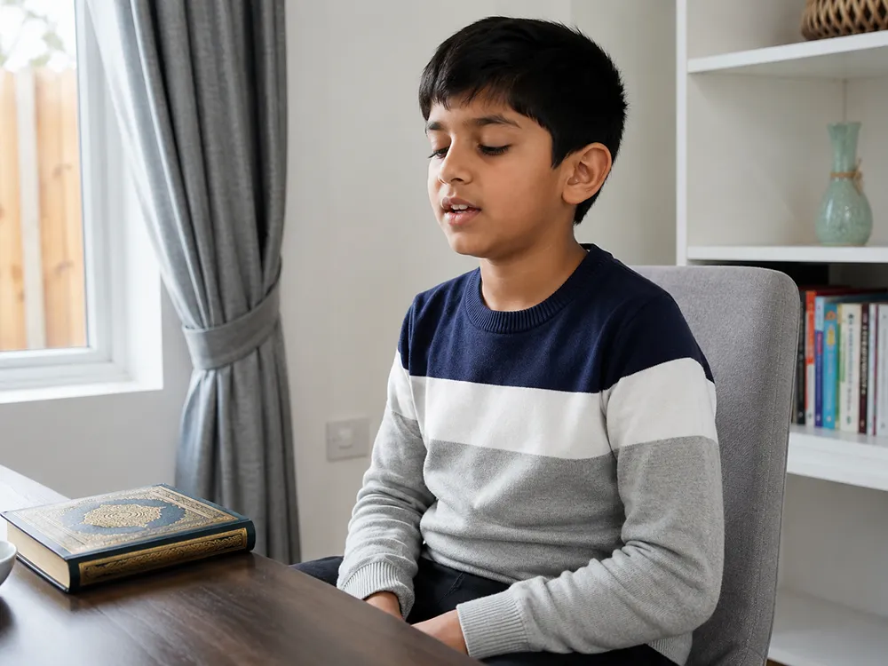 Boy reciting from an open Quran at a desk during an online Tajweed course lesson